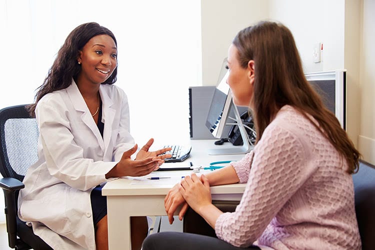 Patient,Having,Consultation,With,Female,Doctor,In,Office Patient Having Consultation With Female Doctor In Office