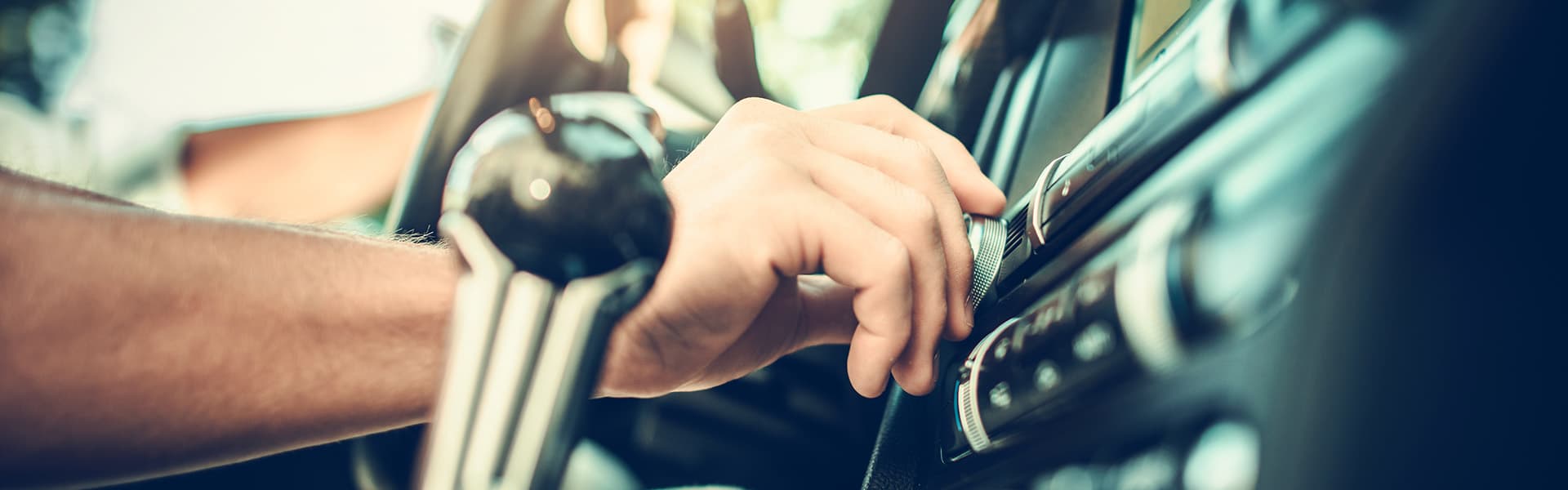 Person increasing volume in car