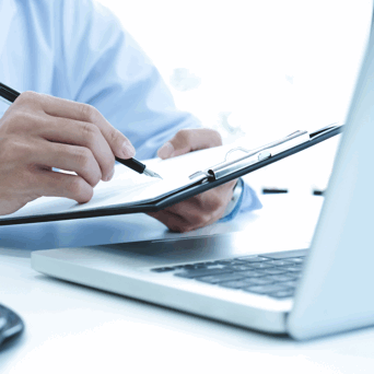 doctor-working-with-laptop-computer-writing-paperwork-hospital-background 1 Reimbursement Coding